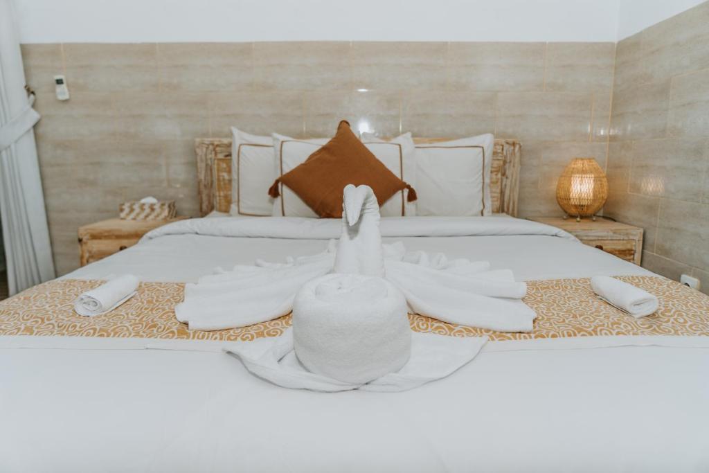 Postel nebo postele na pokoji v ubytování Agung Wiwin Homestay & Restaurant