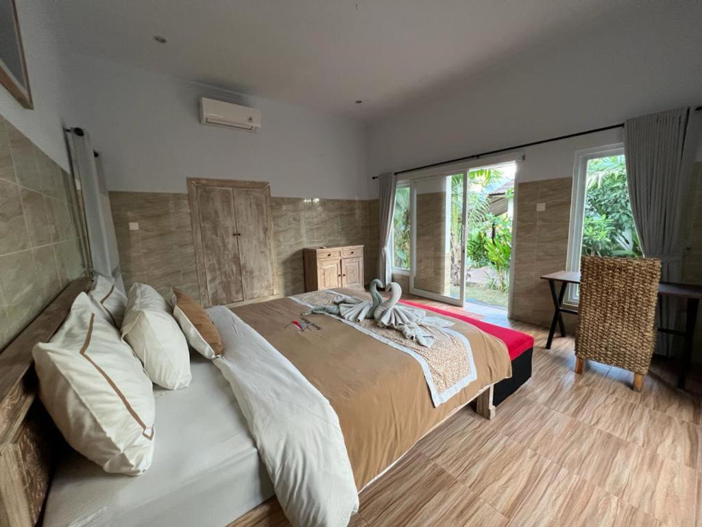Postel nebo postele na pokoji v ubytování Agung Wiwin Homestay & Restaurant