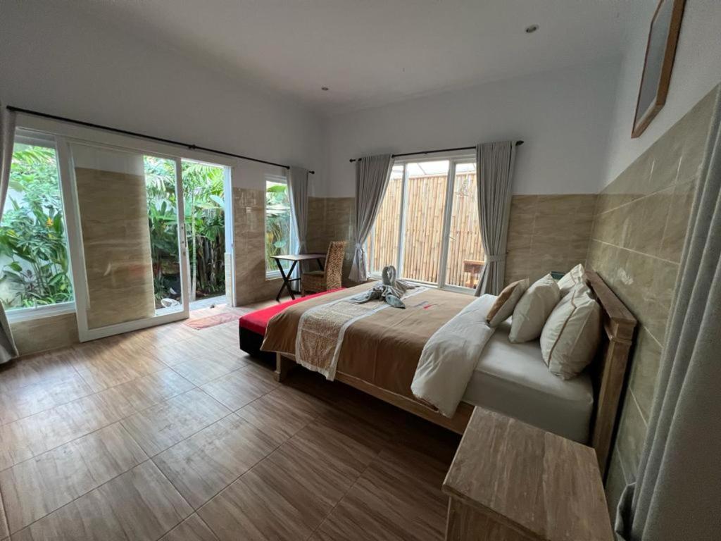 Postel nebo postele na pokoji v ubytování Agung Wiwin Homestay & Restaurant