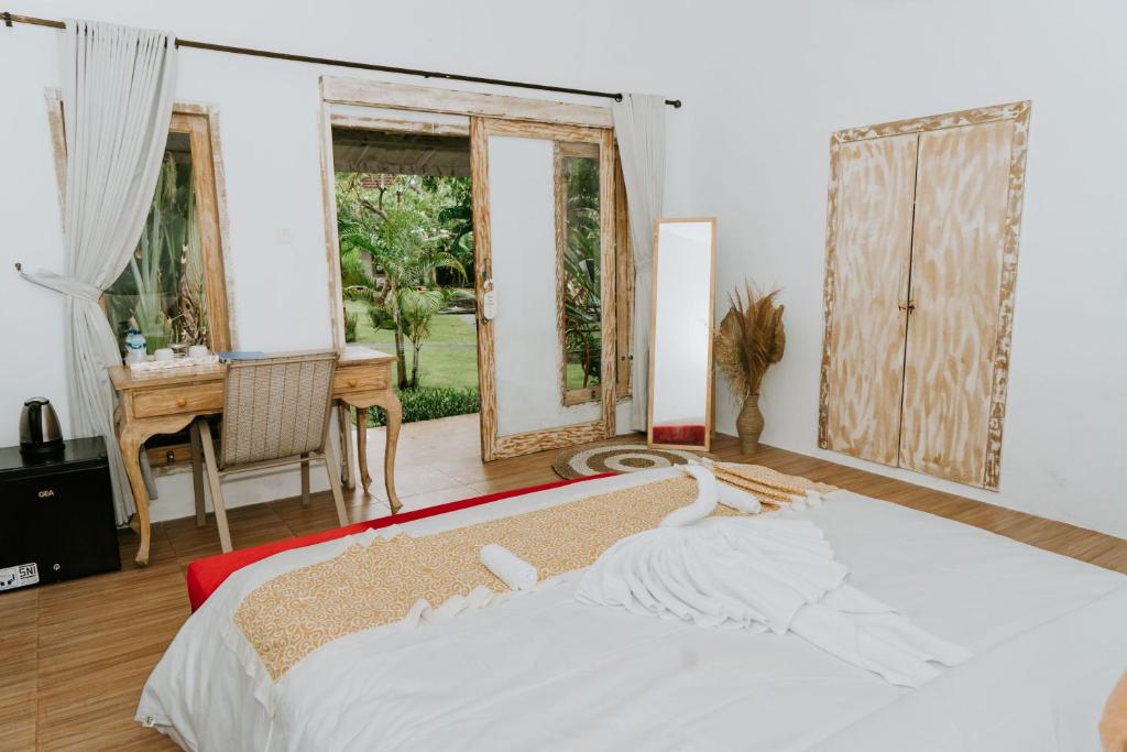 Postel nebo postele na pokoji v ubytování Agung Wiwin Homestay & Restaurant