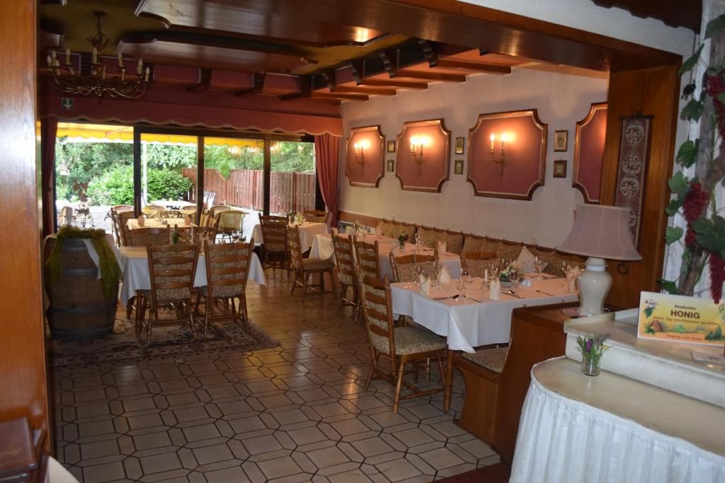 a restaurant with tables and chairs in a room at Alte Dorfschänke in Kinderbeuern