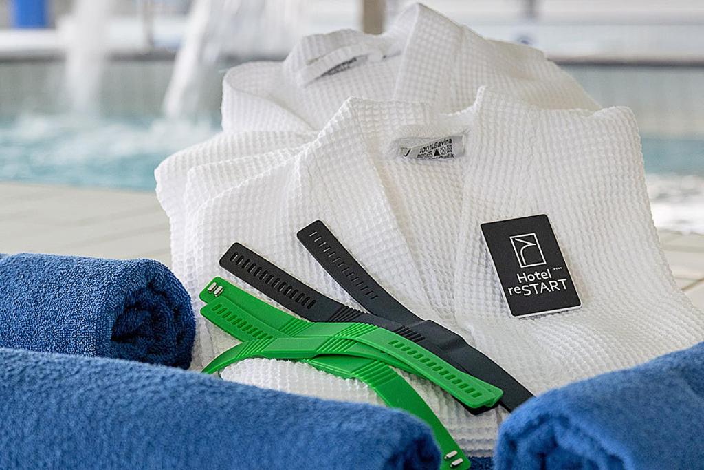 a white shirt with a pair of green handled scissors at Hotel reSTART Superior in Jičín