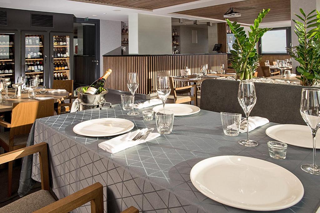 a table in a restaurant with plates and wine glasses at Hotel reSTART Superior in Jičín