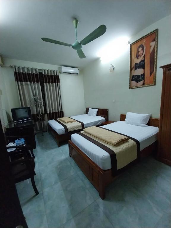 En eller flere senge i et værelse på Khách sạn Mi Sa