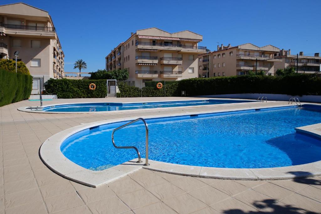 una piscina frente a algunos edificios de apartamentos en AT058 Les Dunes, en Torredembarra