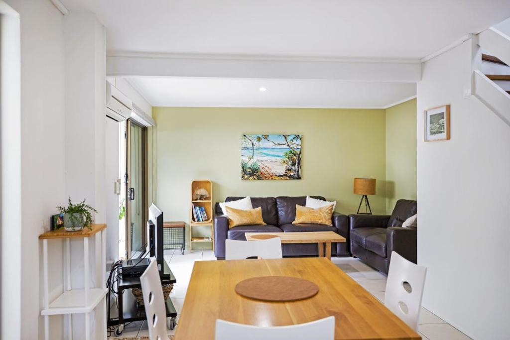 a living room with a couch and a table at Woodside Townhouse Peregian Beach in Peregian Beach