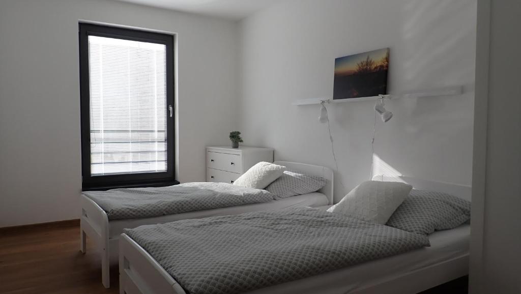 Postel nebo postele na pokoji v ubytování Apartments A + L