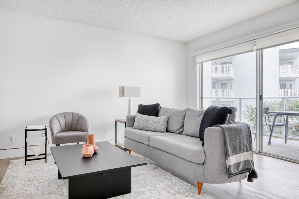 a living room with a couch and a table at Redondo Beach 1BR w Pool Gym WD nr Beach LAX-615 in Redondo Beach