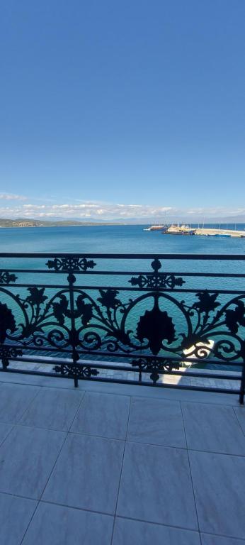 a black metal fence next to a body of water at Leonidas Hotel in Gythio