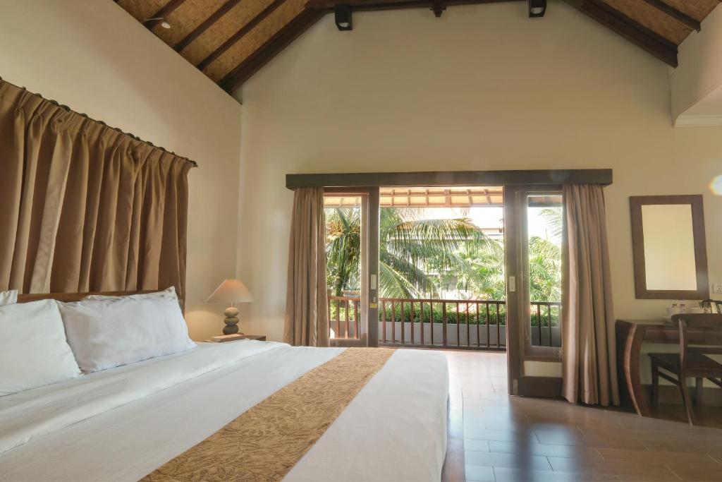 Postel nebo postele na pokoji v ubytování Artini Bisma Ubud Hotel