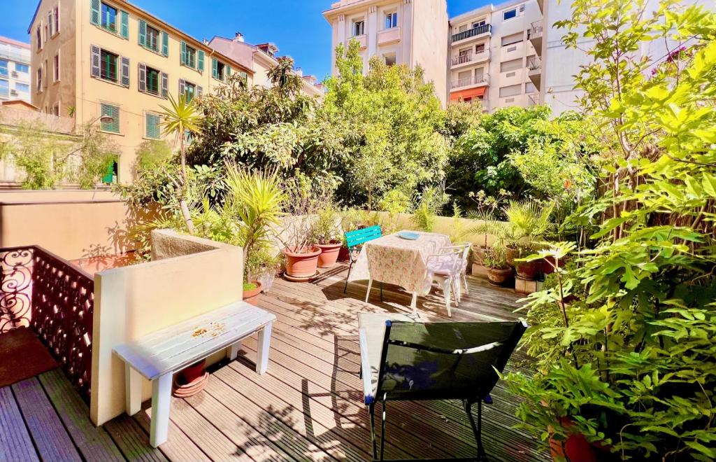 a patio with a table and chairs on a balcony at ApartHotel Riviera - Grimaldi Coeur de Ville - Large Studio AC with bigger South Terrace - Hyper Centre - TERRASSE ESPRIT in Nice