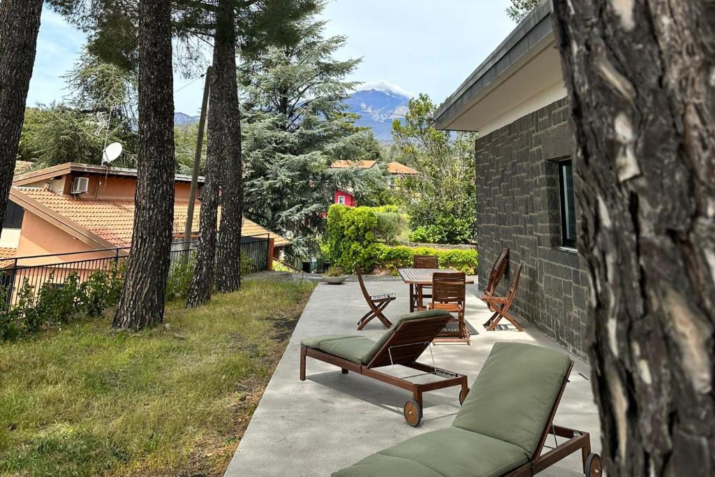 a patio with two chairs and a couch and a table at Terra Lavica Luxury Home Holidays in Nicolosi