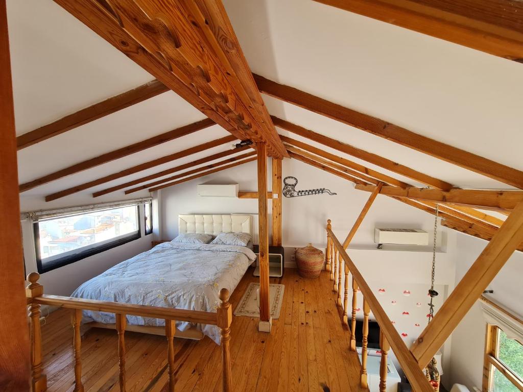 a bedroom with a bed in a room with wooden ceilings at Peramira in Istanbul