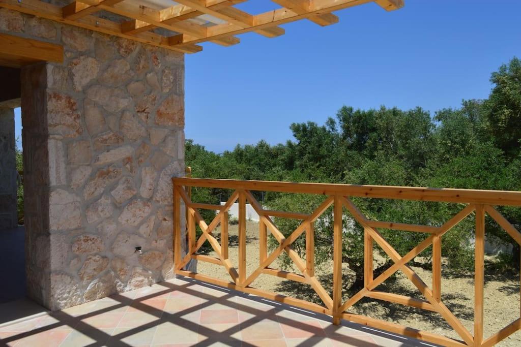 a wooden railing on a porch of a house at Olive Trees in Tragaki