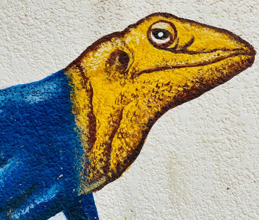 a drawing of a yellow bird on a wall at Le Margouillat 