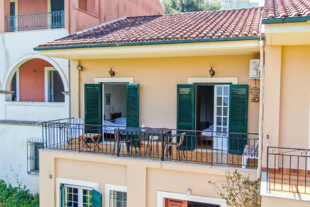 a balcony of a house with green shutters at Villa Prima in Kato Korakiana
