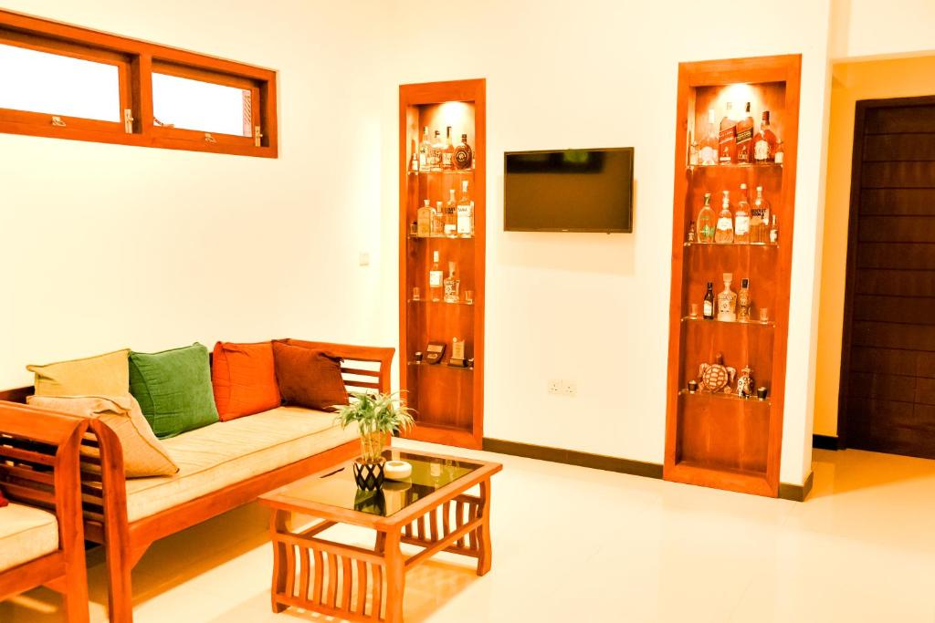 a living room with a couch and a table at Villa Paradise Ocean in Bentota