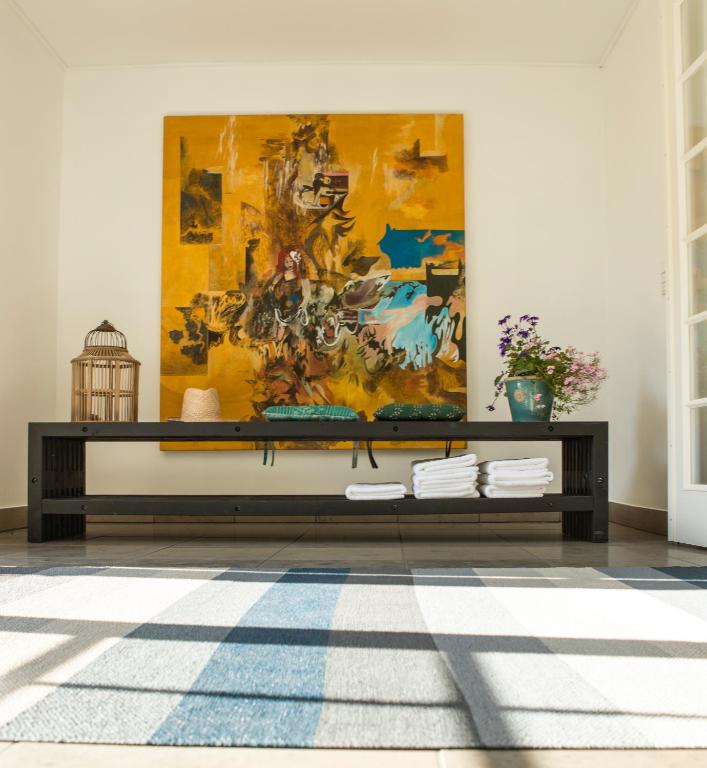 a living room with a large painting on the wall at Femmasteren Hotel & Hostel in Marstal