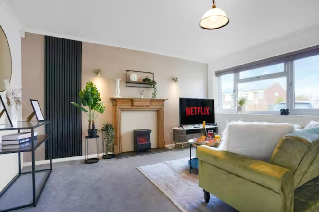 a living room with a couch and a fireplace at Blandford House with Free Parking, Fast Wifi, Smart TV with Netflix and Private Garden by Yoko Property in Coventry