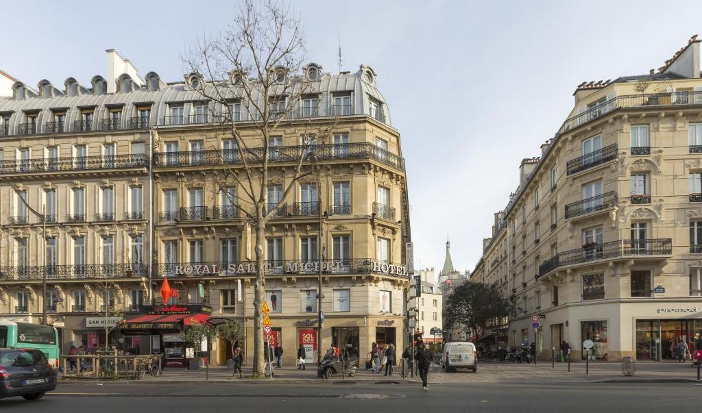 a building on a city street with people and cars at Royal Saint Michel in Paris
