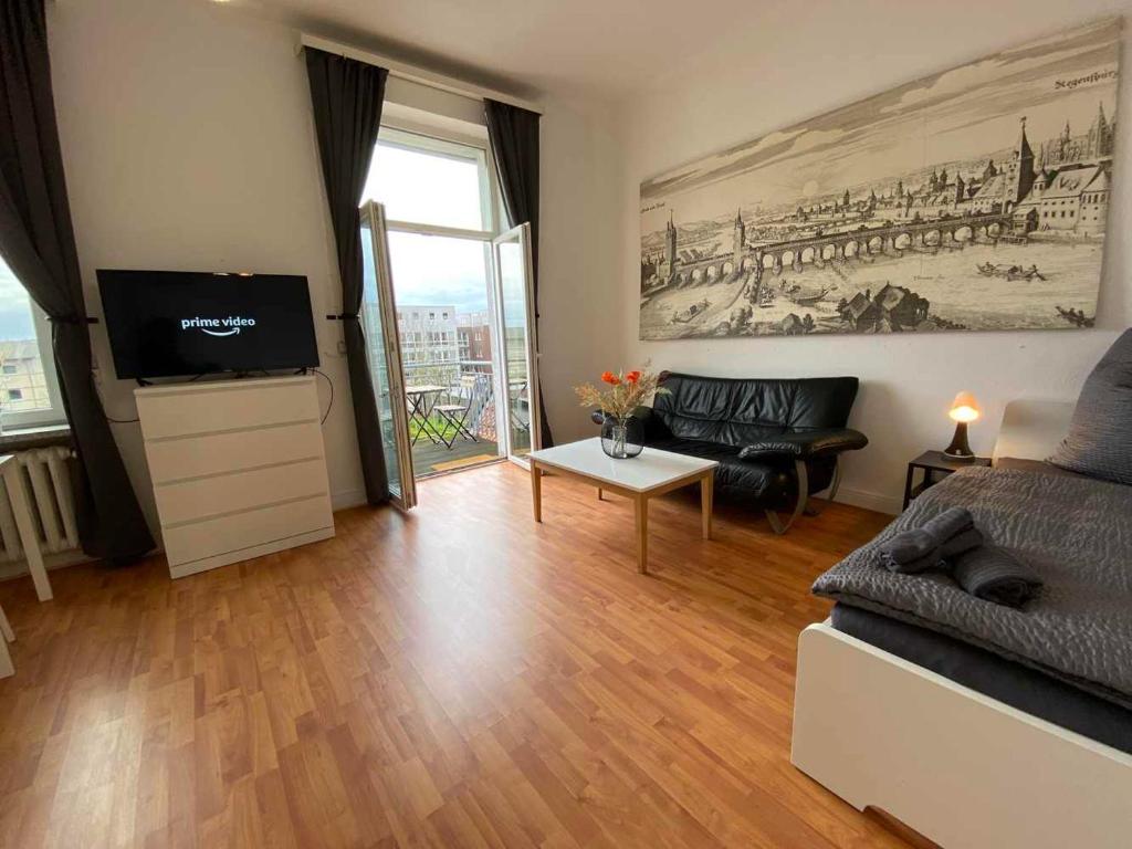 a living room with a couch and a flat screen tv at Apartment with balcony in Lengerich in Lengerich