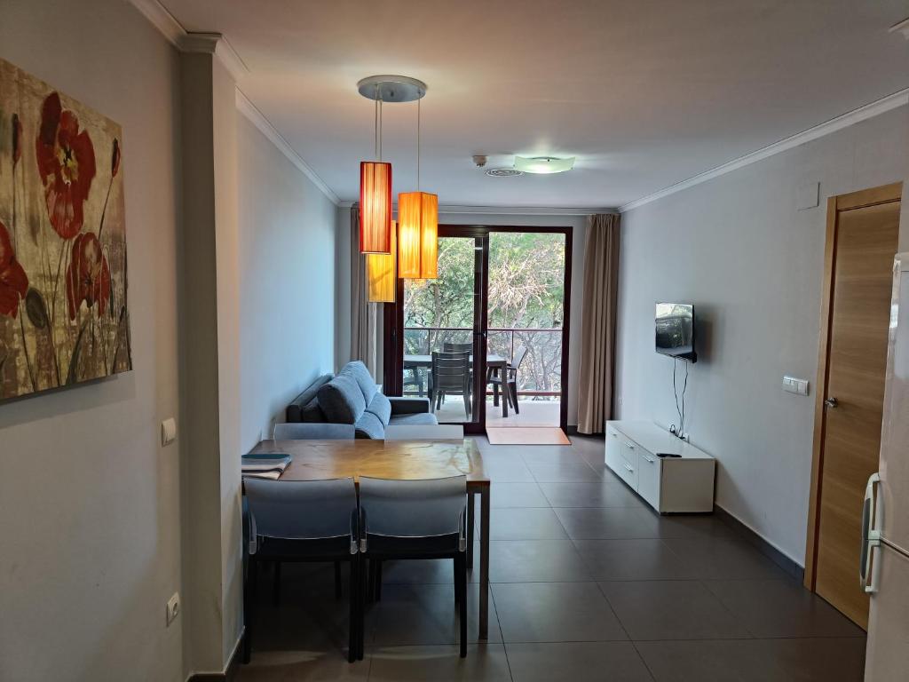 a living room with a table and a couch at Aparthotel El Faro in Cullera