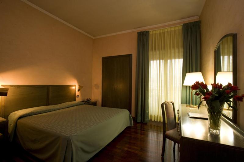 Postel nebo postele na pokoji v ubytování Astor Hotel Vintage