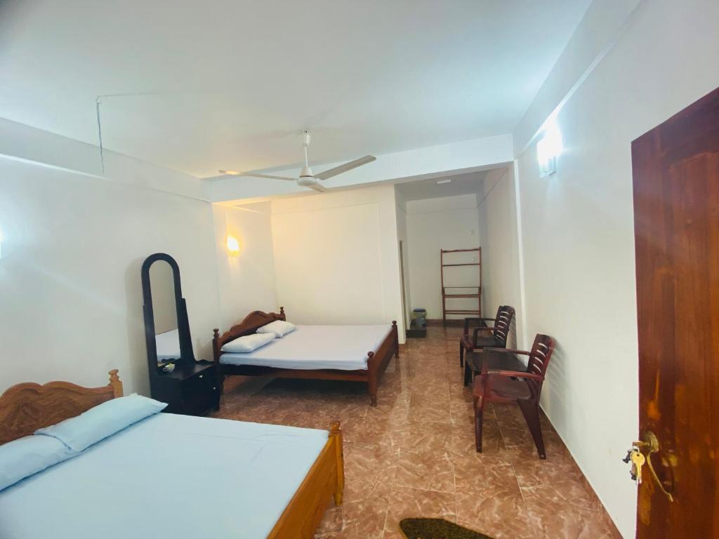 Postel nebo postele na pokoji v ubytování Emerald Guest House