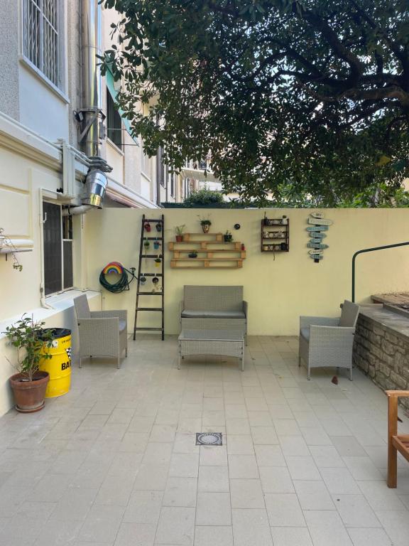 a patio with chairs and tables and a building at 211 Underground in Viareggio