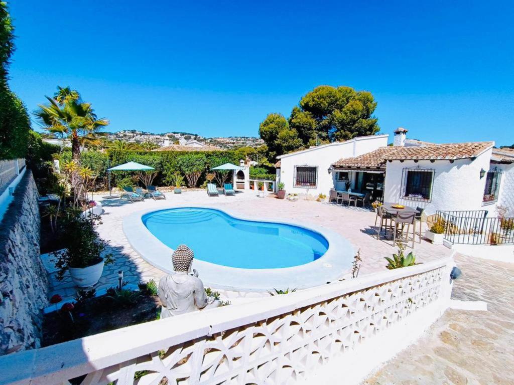 a house with a swimming pool in a yard at 1-Bed Apartment close to Moraira town centre in Moraira