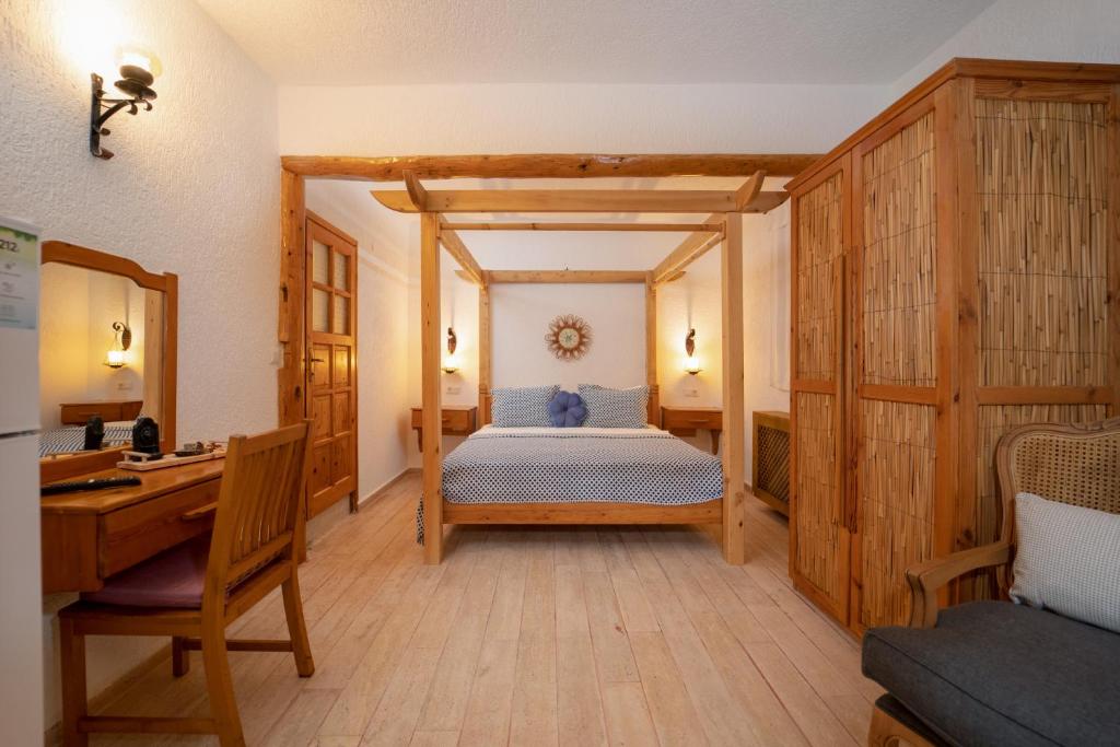 A bed or beds in a room at Watermill Villa & Hotel Faralya