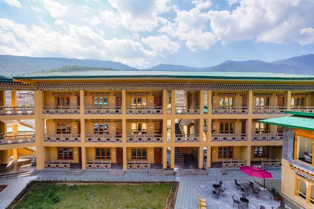 an aerial view of a building with mountains in the background at Shomo Chuki Resort in Paro