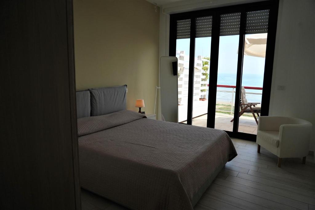 a bedroom with a bed and a view of the ocean at SunRise Apartments in Termoli