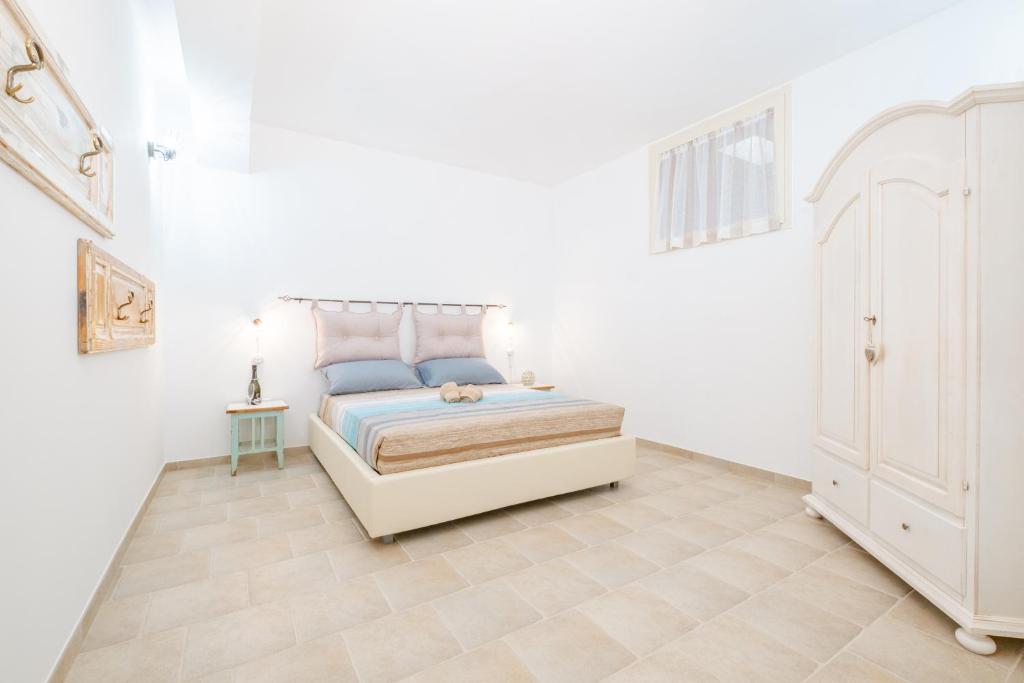 Postel nebo postele na pokoji v ubytování Villa Palamita Luxury - Specchia