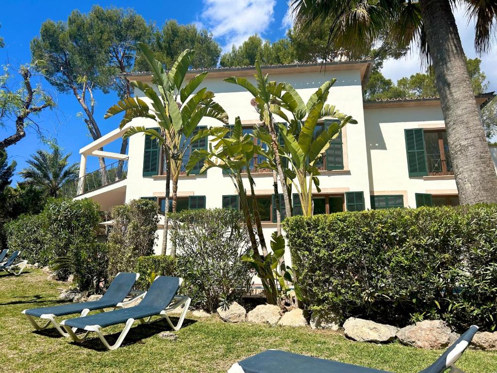 two lounge chairs in front of a house at Beachhouse 2min to the sea with pool & wonderful garden in Calvià
