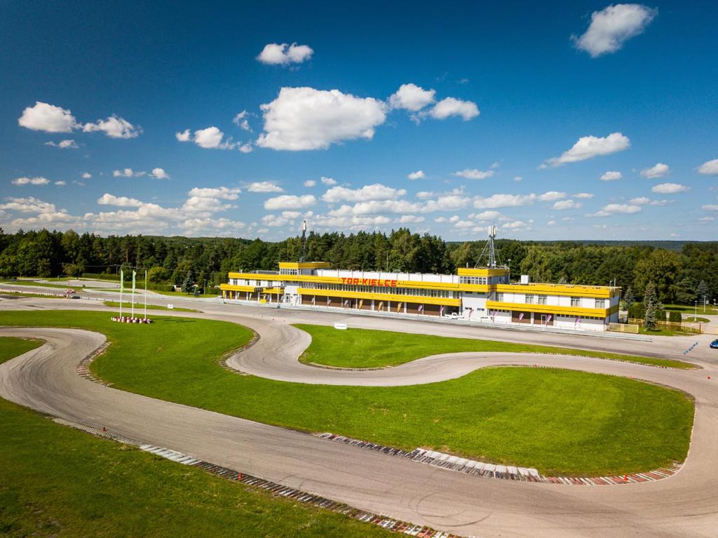 a building with a winding road in front of it at Hotel Tor Kielce in Kielce