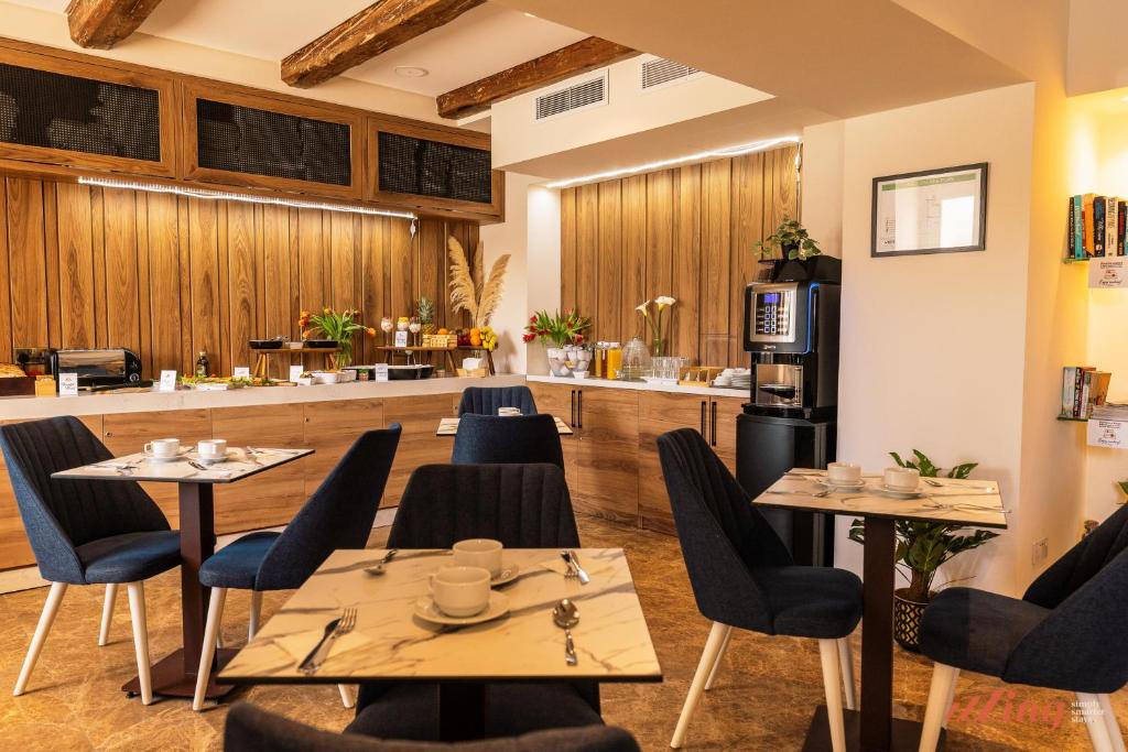 a restaurant with tables and chairs and a counter at El Doris Boutique Living in Marsaskala