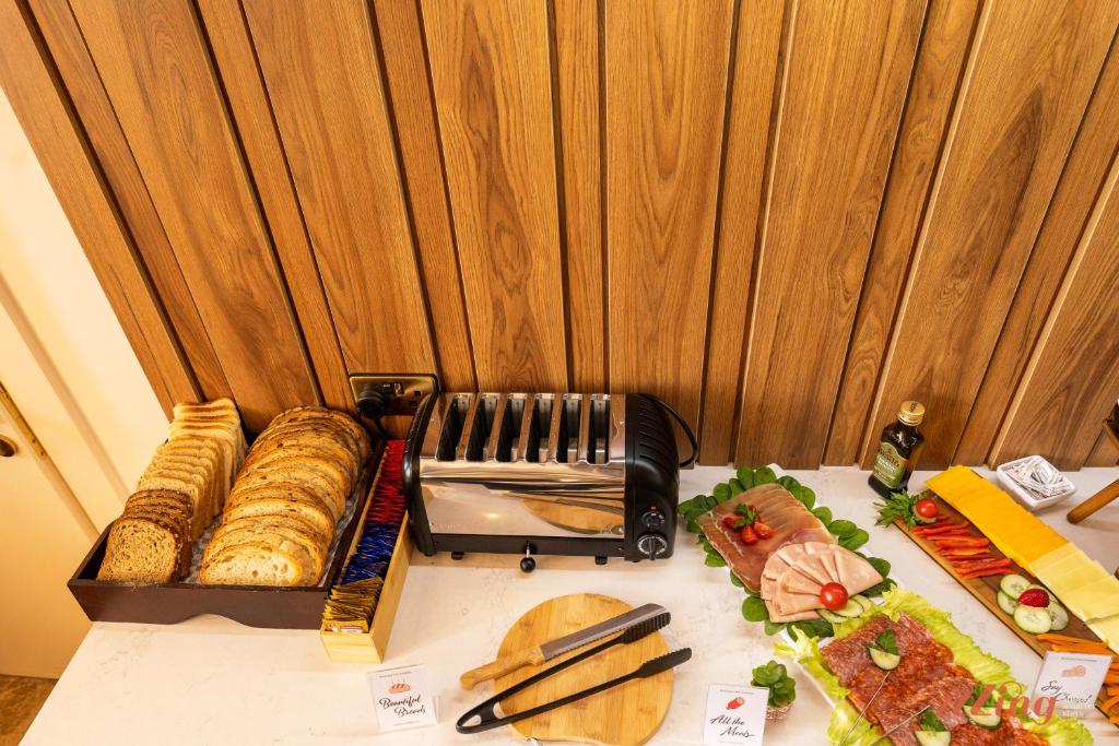 a table with a box of bread and food on it at El Doris Boutique Living in Marsaskala