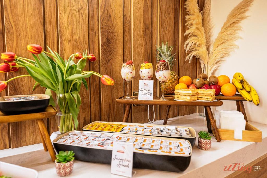 two trays of food on a table with fruits and vegetables at El Doris Boutique Living in Marsaskala