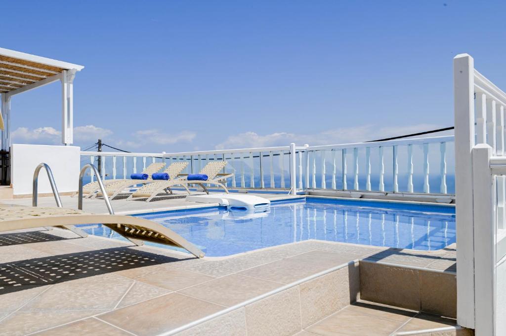 a swimming pool on the roof of a house at Amerisa Suites & Villa in Fira