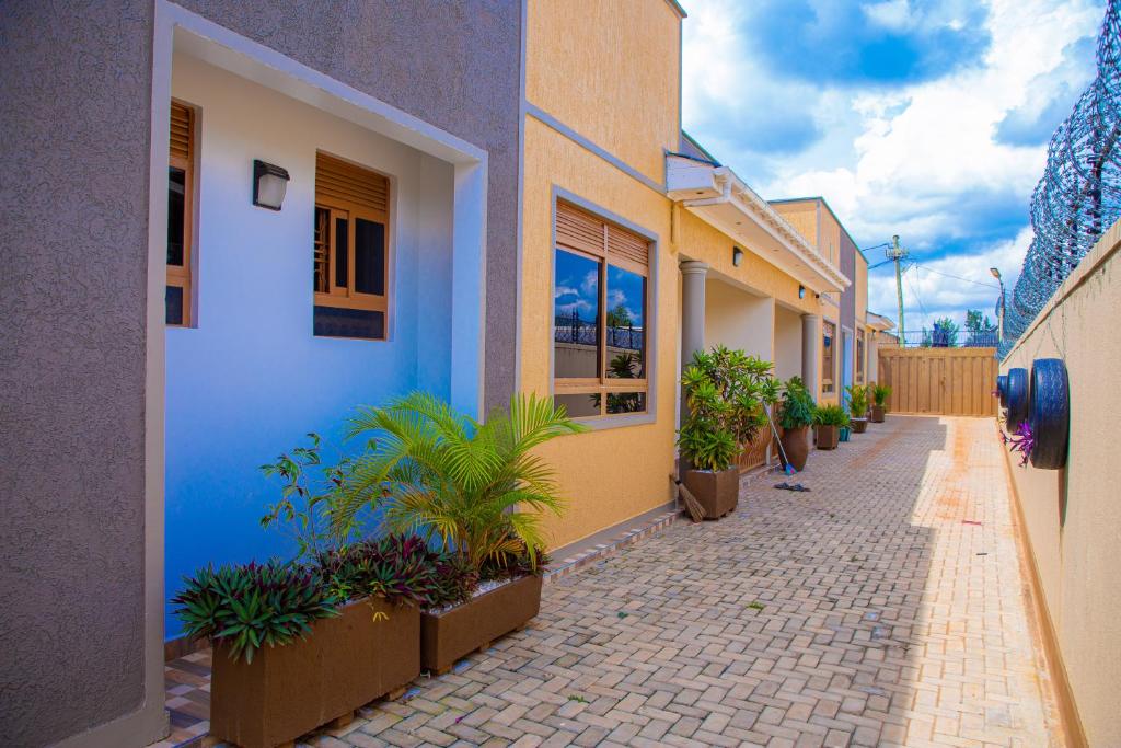 a street with a row of buildings and potted plants at J & A VILLAS in Mbale