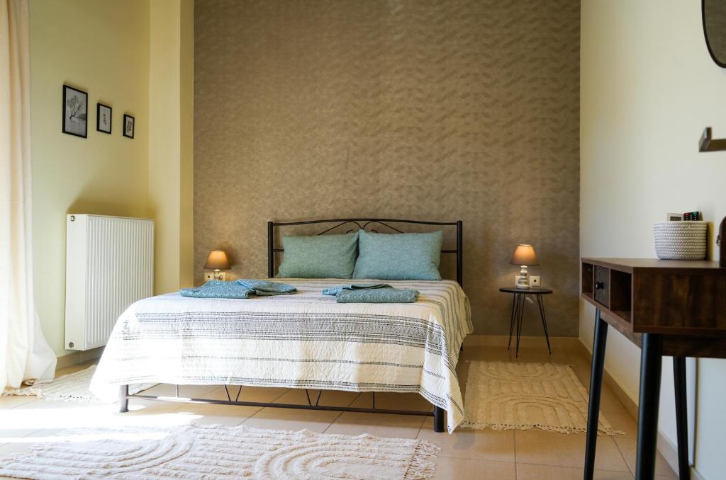 a bedroom with a bed with blue pillows at Aggeliki's guest house in Nafplio