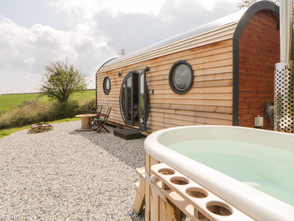 a bath tub sitting next to a building with a sqor at Yealm in Plymouth