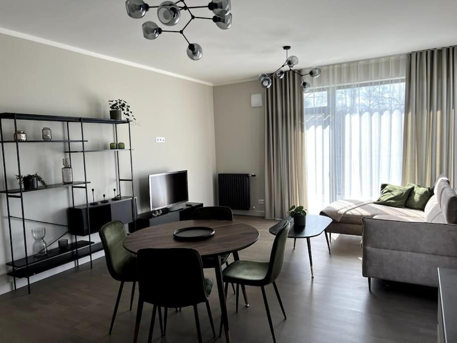 sala de estar con mesa y sofá en Bierinu apartamenti, en Riga