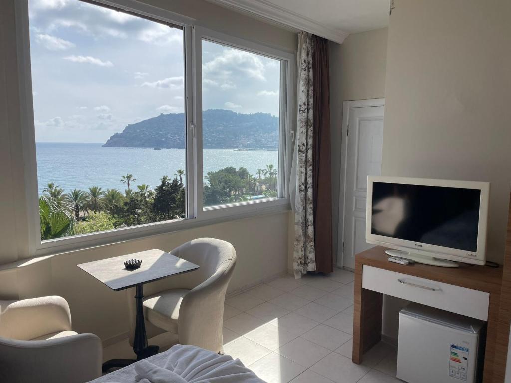 a room with a large window with a view of the ocean at Rosella Hotel in Alanya