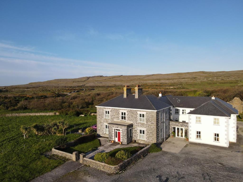 an aerial view of a large house in a field at Kilmurvey House in Kilronan