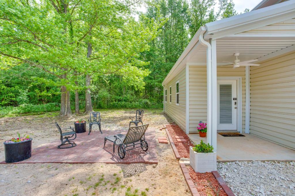 a patio with two chairs and a house at Quiet Mount Vernon Escape Fish, Hike and Unwind! in Mount Vernon