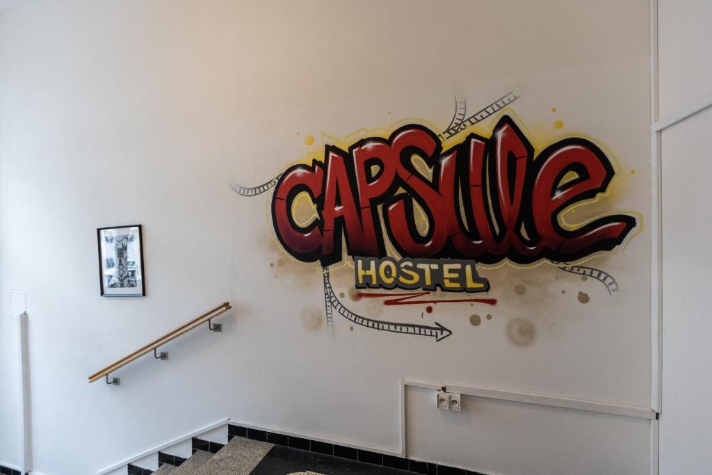 a wall with a sign that reads orange hospital at Capsule hostel Andel Centre SPIRIT in Prague