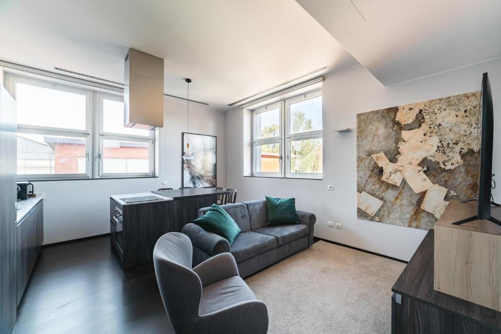 a living room with a couch and some windows at Milan Design Suite - Palestra e Parcheggio Privato in Milan
