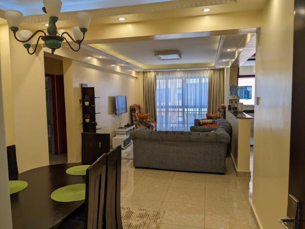 a living room with a couch and a table at Bliss haven gardens two bedroom apartment in Nairobi